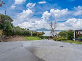 An outdoor area with a sea view at Serenity Above the Lake - Acacia Bay