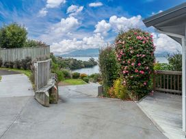A pathway leading to a view of the water at Serenity Above the Lake - Acacia Bay Holiday Home Acacia Bay