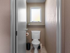 A bathroom with a toilet and shelf at JOE'S Getaway - Omori Holiday Home, Omori