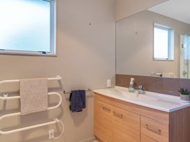 A bathroom with a sink and towel rack at JOE'S Getaway - Omori Holiday Home in Omori