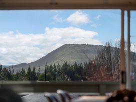 A view of a mountain and trees through a window at JOE'S Getaway - Omori Holiday Home in Omori
