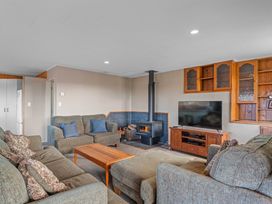A living room with a wood stove and sofa at JOE'S Getaway - Omori Holiday Home in Omori