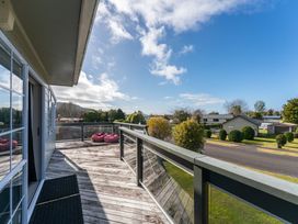 A deck with bean bags and residential buildings at JOE'S Getaway - Omori Holiday Home in Omori