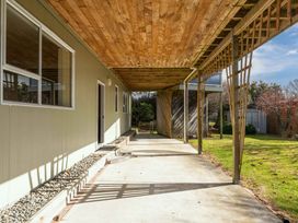 An outdoor patio area with a roof and grass at JOE'S Getaway - Omori Holiday Home in Omori
