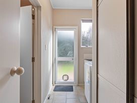 A laundry room with a washing machine and door at JOE'S Getaway - Omori Holiday Home in Omori