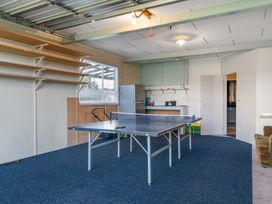 A game room featuring a ping pong table and shelves at JOE'S Getaway - Omori Holiday Home in Omori