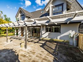 An outdoor seating area with a patio at Hawkings Lodge - Kerikeri Holiday home