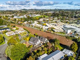 An aerial view of houses and fields at Hawkings Lodge - Kerikeri Holiday home