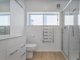 A bathroom with a shower and towel rail at Whangamata Holiday Home Whangamata