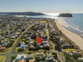 An aerial view of houses and beach at Whangamata Holiday Home in Whangamata