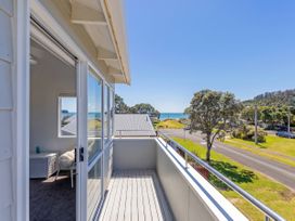 A balcony with ocean view at Whangamata Holiday Home in Whangamata