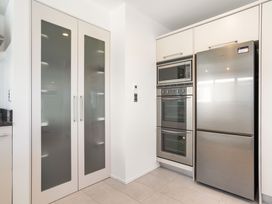 A kitchen with built-in appliances at Sunbrae Sands - Mount Maunganui Holiday Homes Mount Maunganui