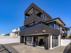 An outdoor view of a modern house with balconies at Sunbrae Sands - Mount Maunganui Holiday Homes Mount Maunganui