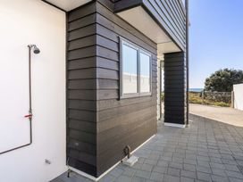 A wall with a window and shower at Sunbrae Sands - Mount Maunganui Holiday Homes