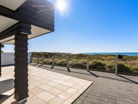 An outdoor area with a view of the ocean at Sunbrae Sands - Mount Maunganui Holiday Homes, Mount Maunganui