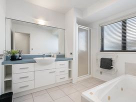 A bathroom with a sink, shower, and bathtub at Sunbrae Sands - Mount Maunganui Holiday Homes in Mount Maunganui