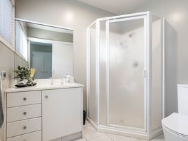 A bathroom with a shower and vanity unit at Sunbrae Sands - Mount Maunganui Holiday Homes, Mount Maunganui