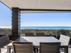 A dining area overlooking the ocean at Sunbrae Sands - Mount Maunganui Holiday Homes Mount Maunganui