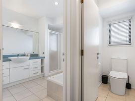 A bathroom featuring a sink, toilet, and shower at Sunbrae Sands - Mount Maunganui