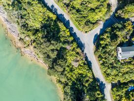 An aerial view of a road intersection near water and surrounded by vegetation at Tepuia Cottage - Havelock Holiday Retreat Marlborough
