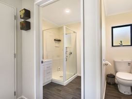 A bathroom with a shower, toilet, and sink at Tepuia Cottage - Havelock Holiday Retreat, Marlborough