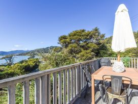 An outdoor deck with a table and chairs at Tepuia Cottage - Havelock Holiday Retreat, Marlborough