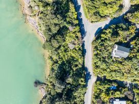 An aerial view of a coastal area with trees and a house at Tepuia Cottage - Havelock Holiday Retreat Marlborough