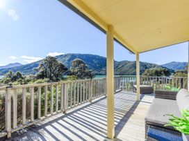 An outdoor space with a deck and view of mountains at Tepuia Cottage - Havelock Holiday Retreat Marlborough