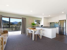 A kitchen with a dining table and chairs at Tepuia Cottage - Havelock Holiday Retreat Marlborough