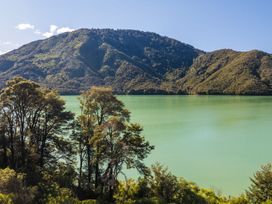 A mountain with greenery and a lake at Tepuia Cottage - Havelock Holiday Retreat Marlborough