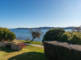 A view of the water and trees at Rainbow Point Yacht Club - Taupo Holiday Home in Taupo