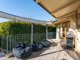 An outdoor area with bean bags and a grill at Rainbow Point Yacht Club - Taupo