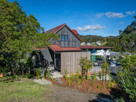 A house with a garden and outdoor seating area at Langs Beach Holiday Home in Langs Beach