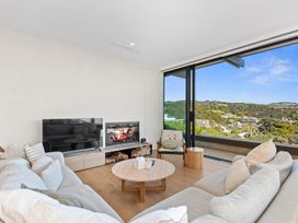A living room with a sofa and television at Langs Beach Holiday Home in Langs Beach