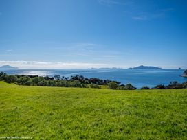 A view of the ocean and islands from a grassy area at Langs Beach Holiday Home in Langs Beach
