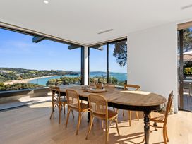 A dining room with a view at Langs Beach Holiday Home in Langs Beach