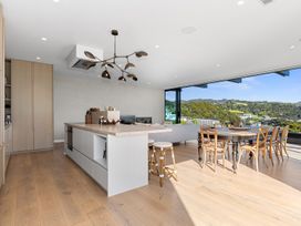 A kitchen with an island and dining area at Langs Beach Holiday Home in Langs Beach