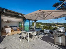 An outdoor patio with a table and chairs at Langs Beach Holiday Home in Langs Beach