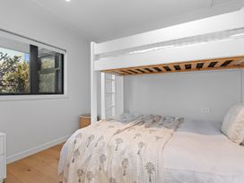 A bedroom with a bunk bed and a window at Langs Beach Holiday Home in Langs Beach