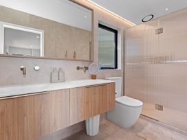 A bathroom with a shower, sink, and toilet at Langs Beach Holiday Home, Langs Beach
