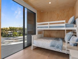 A bedroom with a bunk bed and a view at Langs Beach Holiday Home in Langs Beach