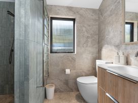 A bathroom with shower, toilet, and sink at Langs Beach Holiday Home, Langs Beach