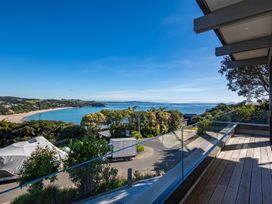 A balcony view overlooking a beach and water at Langs Beach Holiday Home in Langs Beach