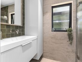A bathroom with a sink and mirror at Langs Beach Holiday Home in Langs Beach