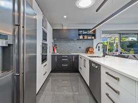 A kitchen with appliances and countertops at Endeavour Oasis - Whitianga Holiday Home, Whitianga