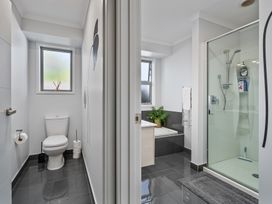 A bathroom with a toilet, bathtub, and shower at Endeavour Oasis - Whitianga