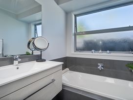 A bathroom with a bath tub and sink at Endeavour Oasis - Whitianga Holiday Home in Whitianga