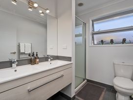 A bathroom with a sink, shower, and toilet at Endeavour Oasis - Whitianga Holiday Home, Whitianga