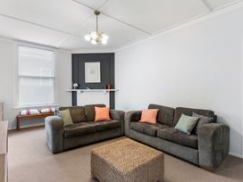 A living room with sofas and a coffee table at Auckland Holiday Home in Auckland