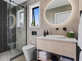 A bathroom with a shower and sink at Mangawhai Holiday Home, Mangawhai